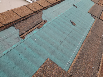 屋根材が剥がれて防水紙がむき出しになっている
