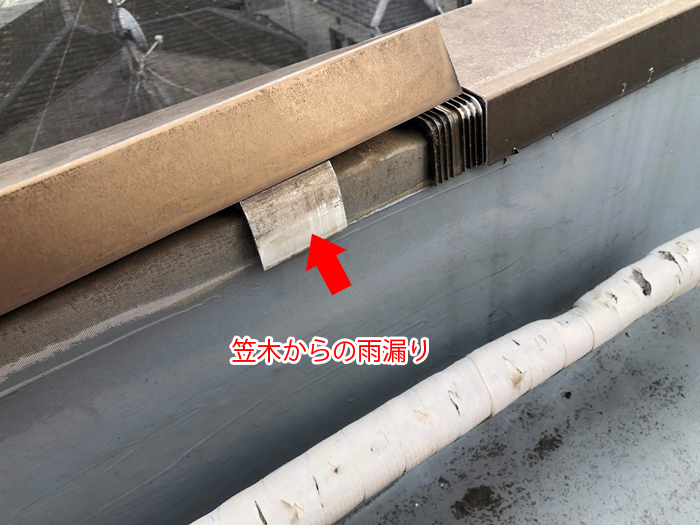 笠木部分と雨漏り箇所を赤い矢印で示した写真
