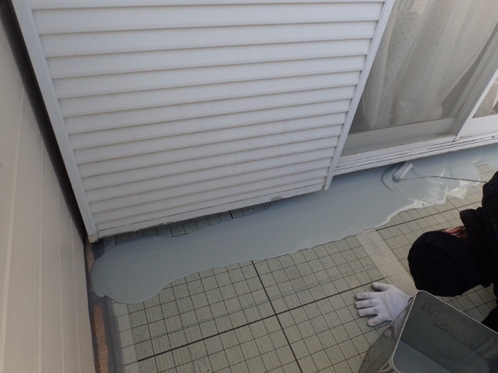 ウレタン防水塗料の主剤と硬化剤を混合しベランダの床面に塗布